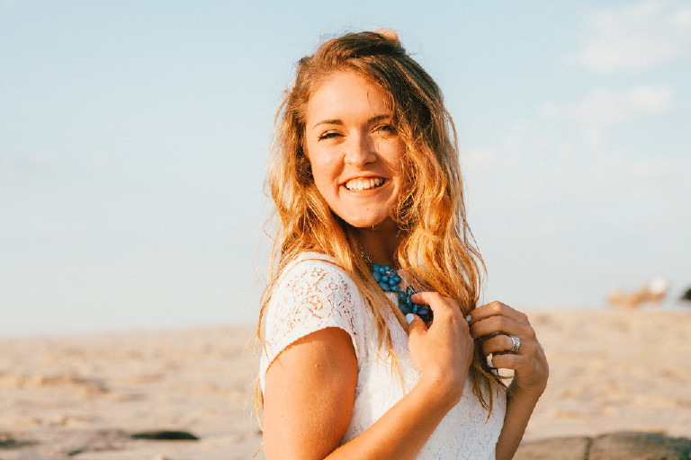 Kaitlyn smiling at Asbury Park Beach for unique Jersey Shore Senior Photos