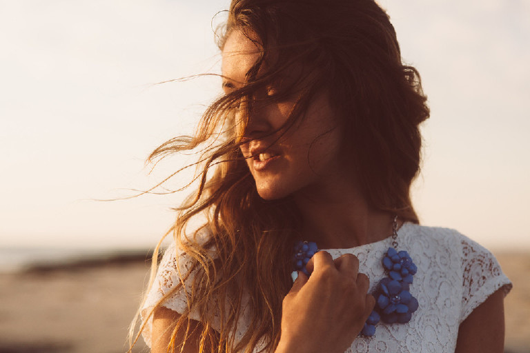 wind in hair at Asbury Park Beach for unique Jersey Shore Senior Photos by Kasey Ivan Photography