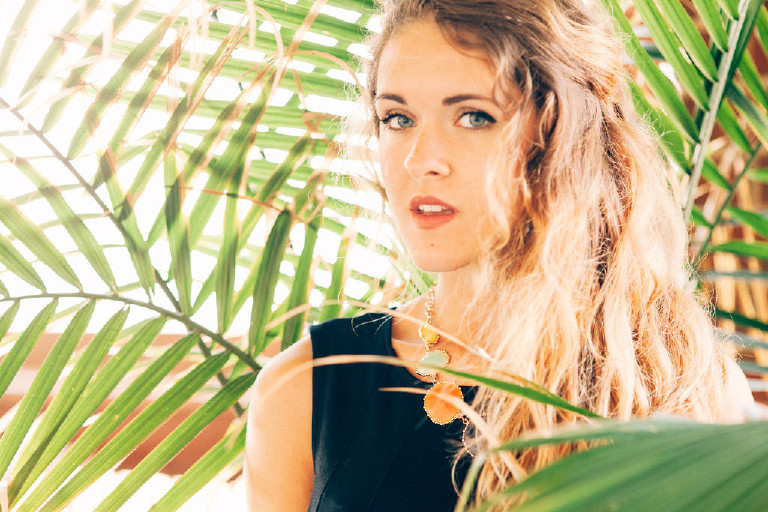 Kaitlyn in Palm fronds for unique Jersey Shore Senior Photos by Kasey Ivan Photography