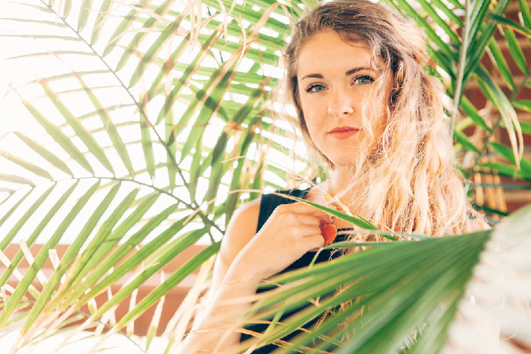 Kaitlyn in Palm fronds for unique Jersey Shore Senior Photos by Kasey Ivan Photography