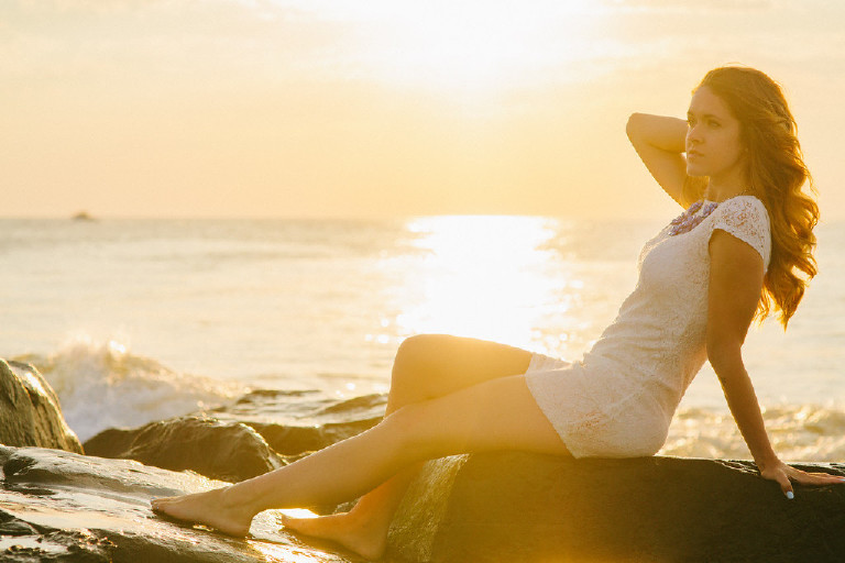 Kaitlyn reclining on rock at Asbury Park by Jersey Shore for Senior Photos with Kasey Ivan