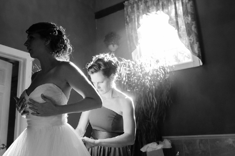 Kolbi the bride tries on her dress at Chimney Hill Estate wedding in Lambertville NJ