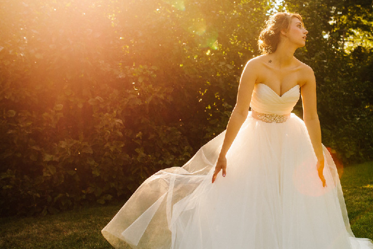 Kolbi the bride and lens flare photo in nature at Chimney Hill Estate wedding in Lambertville NJ