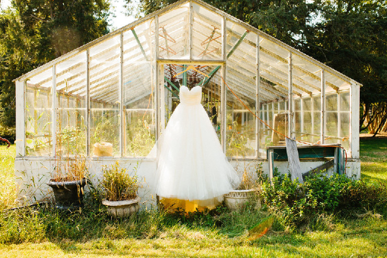 wedding dress hanging from greenhouse wedding at Chimney Hill Estate in Lambertville