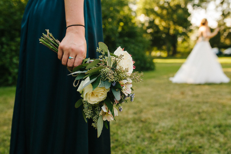 bridesmaid holding bouquet of flowers with bride Kolbi the bride at Chimney Hill Estate wedding in Lambertville NJ