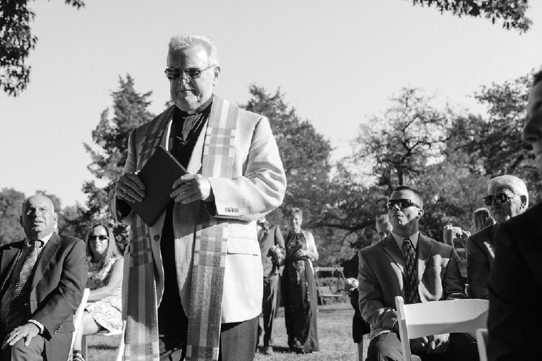 priest walks down the aisle to ceremony at Chimney Hill Estate wedding in Lambertville NJ