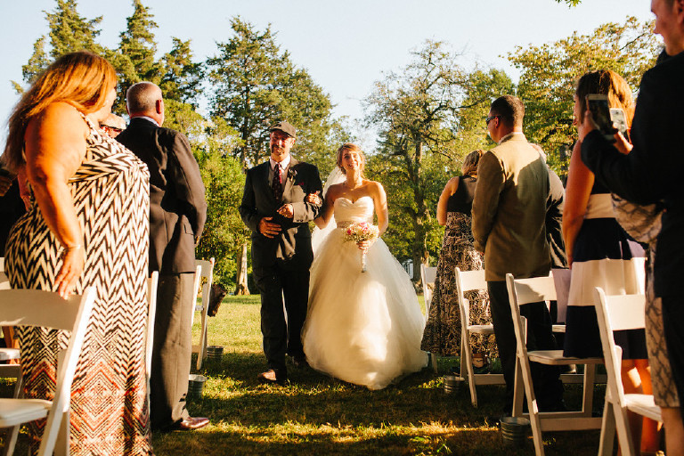 sun drenched bride walking down aisle at Chimney Hill Estate wedding ceremony in Lambertville NJ