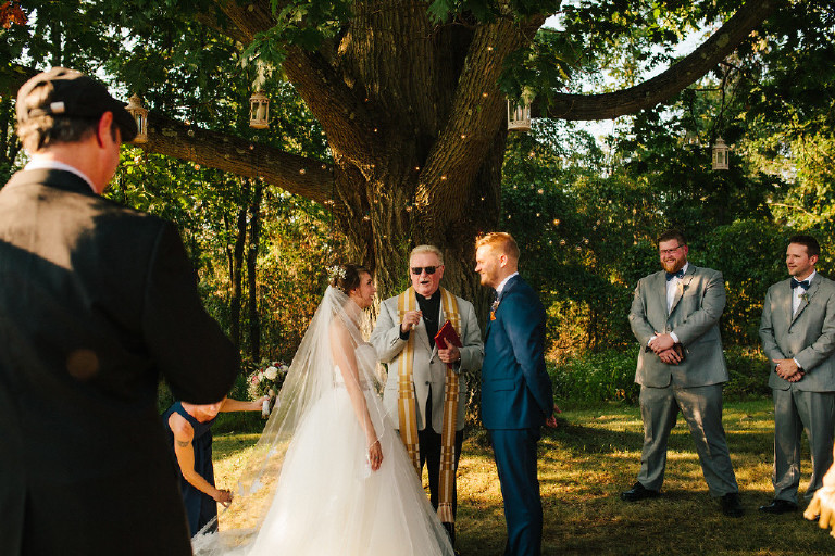 bride and groom in front of big tree at Chimney Hill Estate wedding ceremony in Lambertville NJ