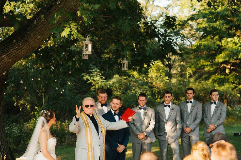 priest extends hands to celebrate couple at Chimney Hill Estate wedding ceremony in Lambertville NJ
