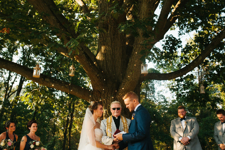 groom reading hand written vows at Chimney Hill Estate wedding ceremony in Lambertville NJ