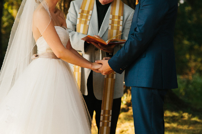 couple holding hands during Chimney Hill Estate wedding ceremony in Lambertville NJ by Kasey Ivan Photography