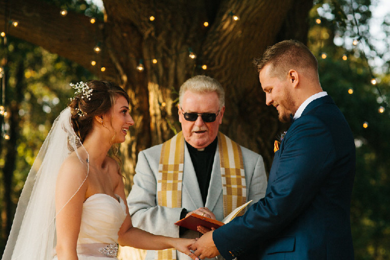 bride receives wedding ring and laughs during Chimney Hill Estate wedding ceremony in Lambertville NJ by Kasey Ivan Photography