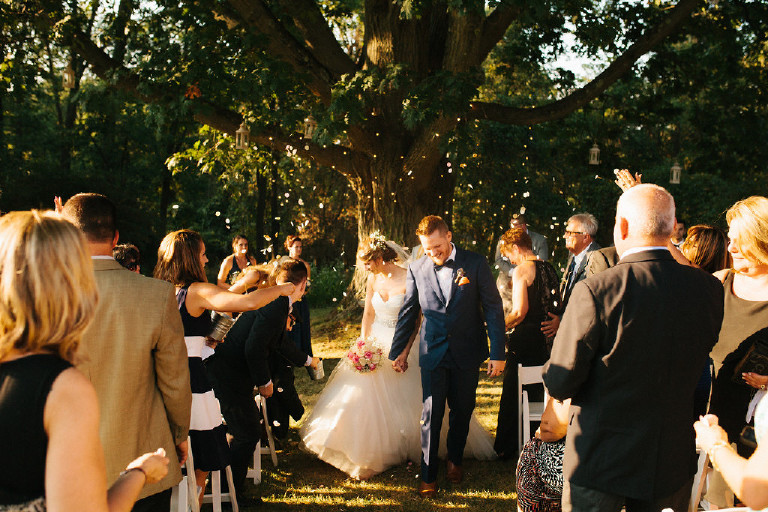 bride and groom exit down aisle while confetti is thrown during Chimney Hill Estate wedding ceremony in Lambertville NJ by Kasey Ivan Photography