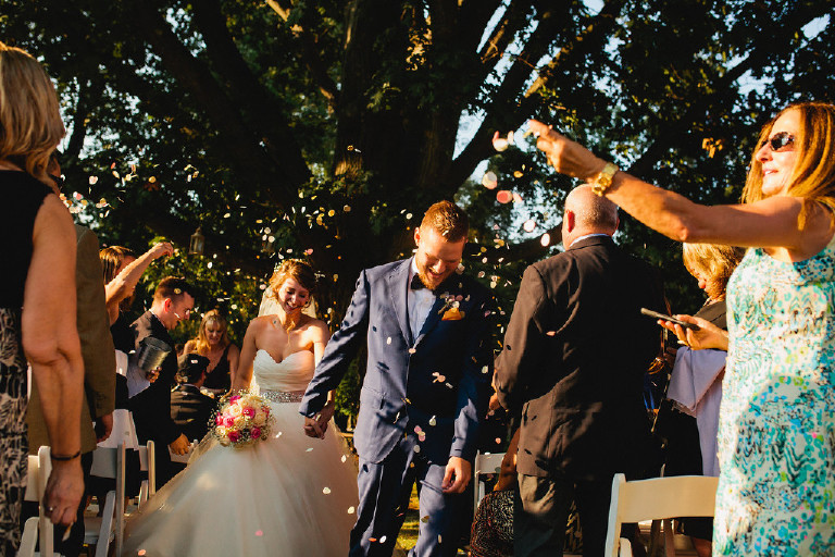 bride and groom exit down aisle with confetti during Chimney Hill Estate wedding ceremony in Lambertville NJ by Kasey Ivan Photography