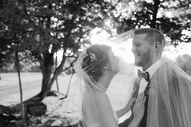 black and white laughing goom under veil at Chimney Hill Estate wedding in Lambertville by Kasey Ivan Photography