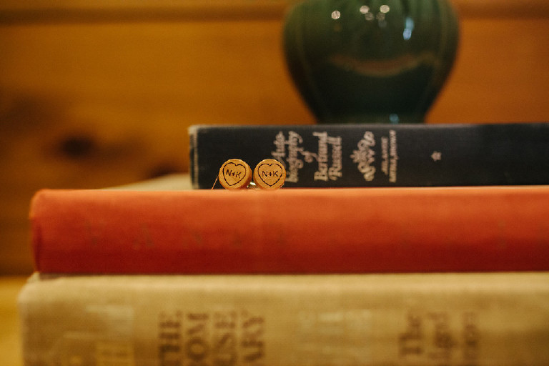 unique initialed cufflinks sitting on books at Chimney Hill Estate wedding in Lambertville