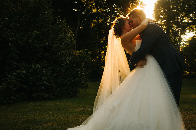 groom dips the bride during sunset at Chimney Hill Estate wedding in Lambertville by Kasey Ivan Photography