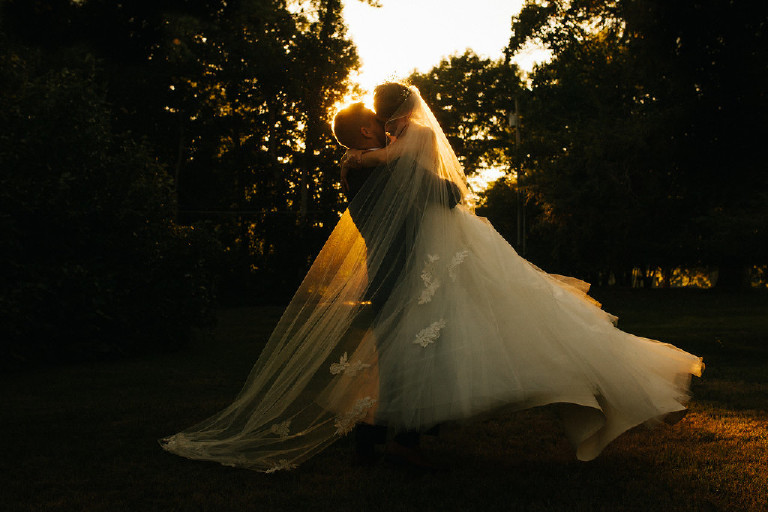 groom twirls the bride in sweeping flowing wedding dress at Chimney Hill Estate wedding in Lambertville by Kasey Ivan Photography