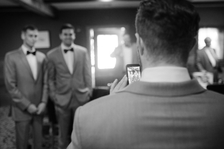 groomsmen taking cell phone photo at Chimney Hill Estate wedding in Lambertville