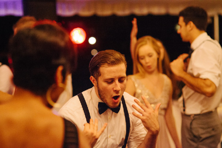 guests sing and party under canopy tent at Chimney Hill Estate wedding reception by Kasey Ivan Photography