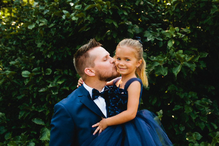 groom kissing the flower girl at Chimney Hill Estate wedding in Lambertville