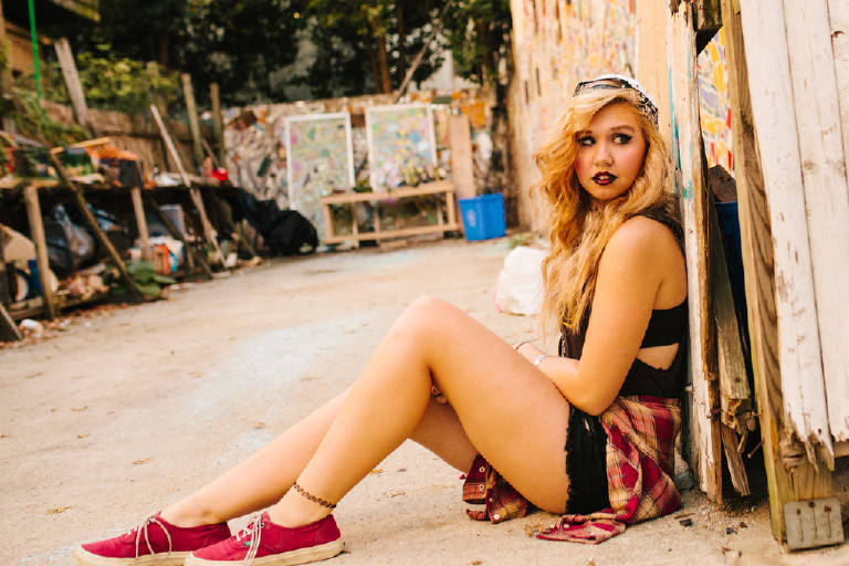 Kassi sitting outside Magic Garden South Street in Philadephia for senior photos by Kasey Ivan Photography