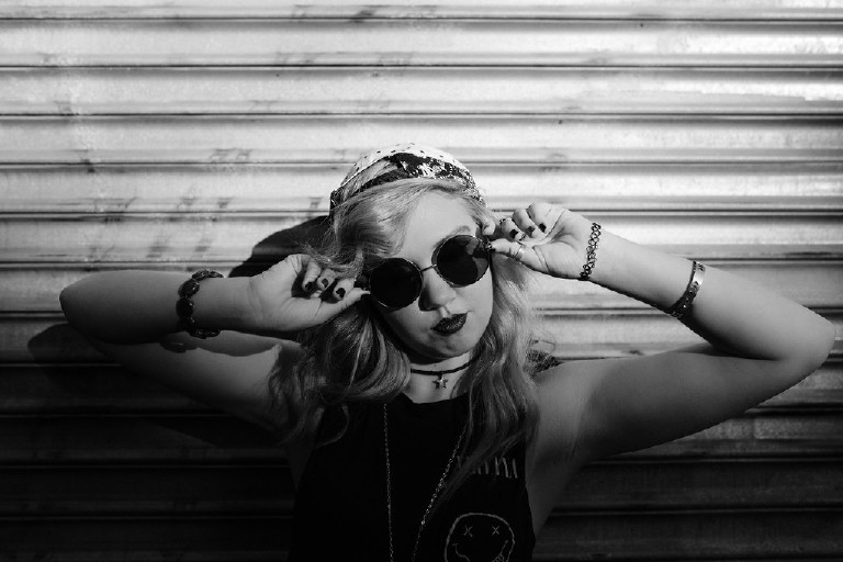 having fun in Nirvana shirt with sunglasses in downtown Philadelphia for senior photos by Kasey Ivan Photography