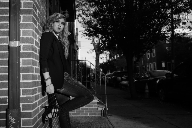 moody emotive black and white photo against wall in downtown Philadelphia for senior photos by Kasey Ivan Photography