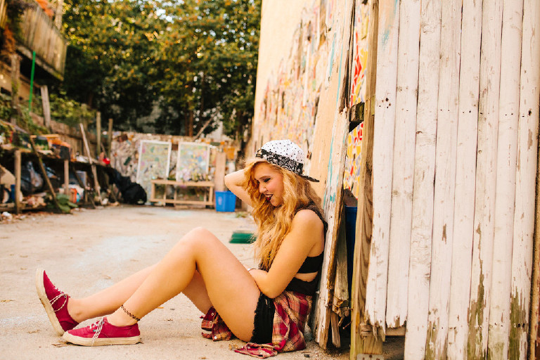 sitting in alley outside Magic Garden South Street in Philadephia for senior photos by Kasey Ivan Photography