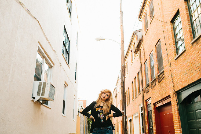 posing in small Philly side street in downtown Philadelphia for senior photos by Kasey Ivan Photography