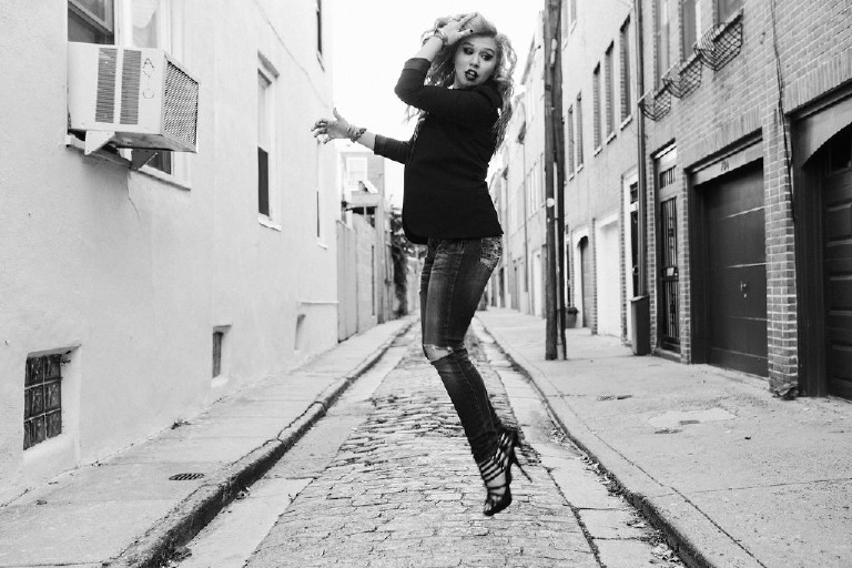 jumping fashion photo in heels in downtown Philadelphia for senior photos by Kasey Ivan Photography