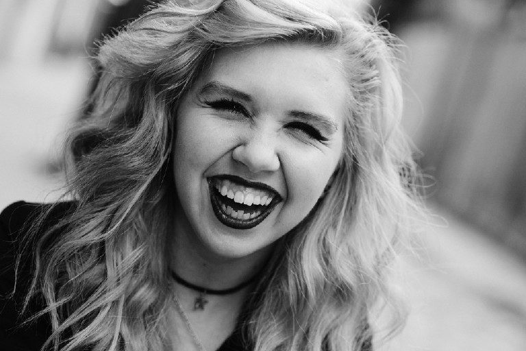 laughing Kassi in downtown Philadelphia for senior photos by Kasey Ivan Photography