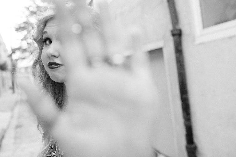 hand in camera paparazzi in downtown Philadelphia for senior photos by Kasey Ivan Photography