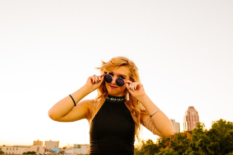 sassy girl with glasses on rooftop for senior photos in downtown south street philadelphia by Kasey Ivan Photography