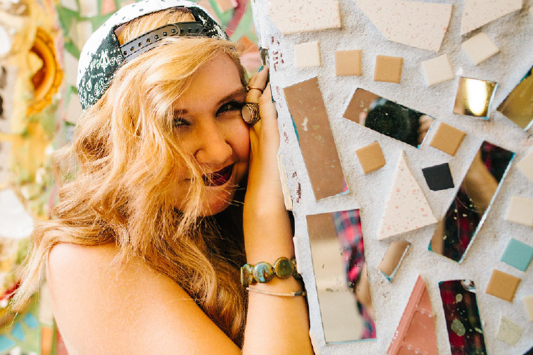 smiling Kassi outside Magic Garden South Street in Philadephia for senior photos by Kasey Ivan Photography