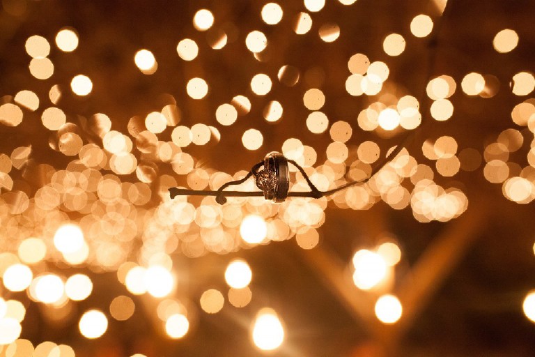 wedding rings shot with christmas lights in the poconos by Kasey Ivan Photography