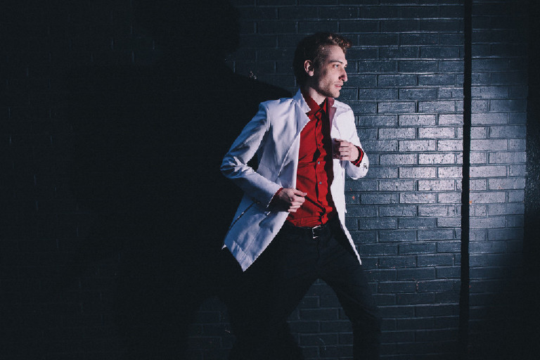 male model running down Philadelphia alley for fashion editorial outside China Town by Kasey Ivan Photography