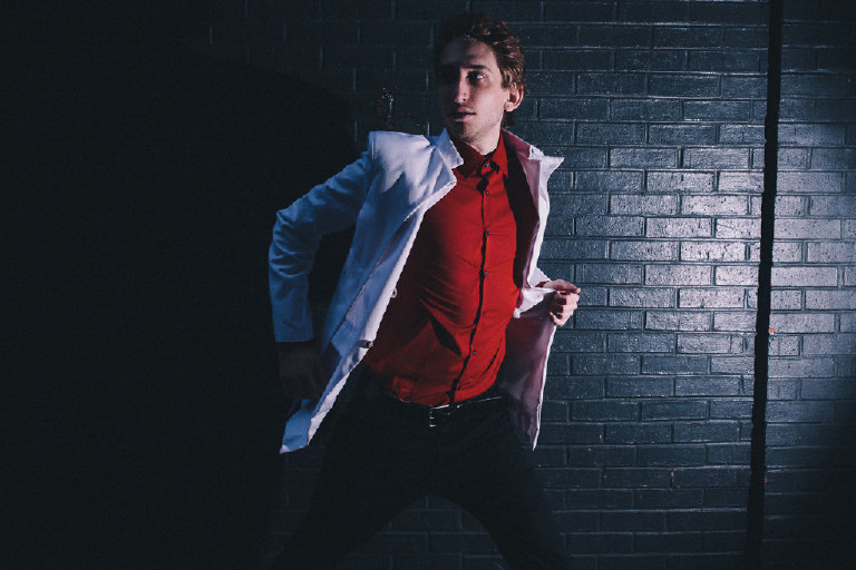 male model running down Philadelphia alley for fashion editorial outside China Town by Kasey Ivan Photography