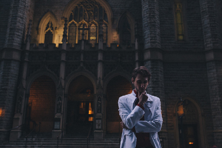 male model posing outside Philadelphia cathedral for fashion editorial outside China Town by Kasey Ivan Photography