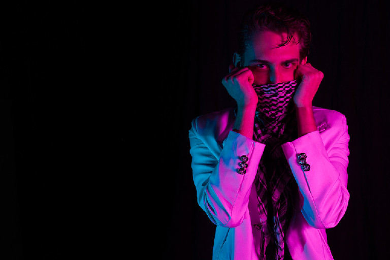 male posing in portrait in pink and blue studio light by New Hope and Lambertville photographer Kasey Ivan