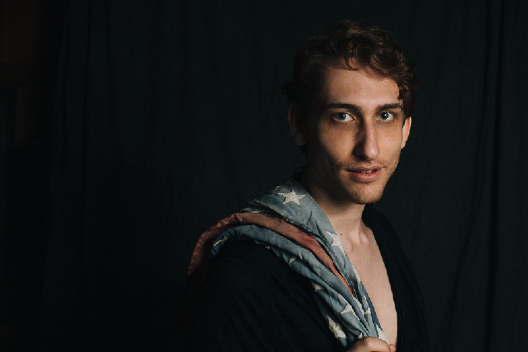 male posing with american flag in portrait in dramatic studio light by New Hope and Lambertville photographer Kasey Ivan