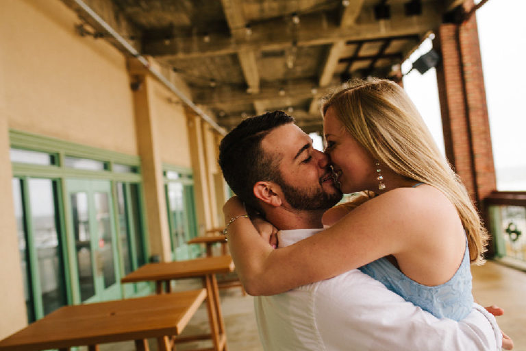 Jenna and Ryan lean in for a kiss by Asbury Park beach for engagement photos 