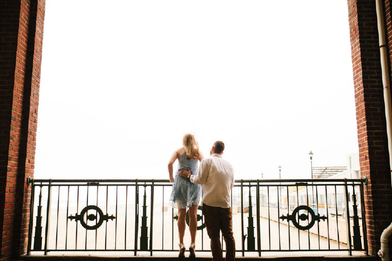 Stunning photograph of couple looking at Asbury Park beach for their engagement photos by Kasey Ivan Photography