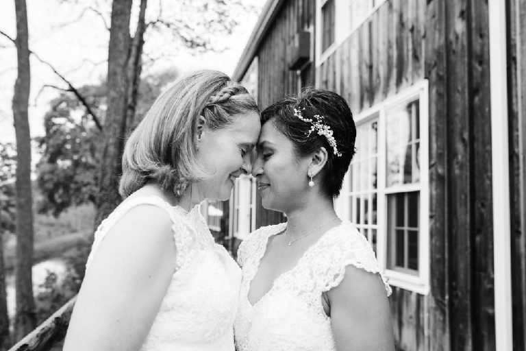 lesbian couple gives eskimo kiss outside 1740 House before same sex wedding in New Hope PA by Kasey Ivan photography
