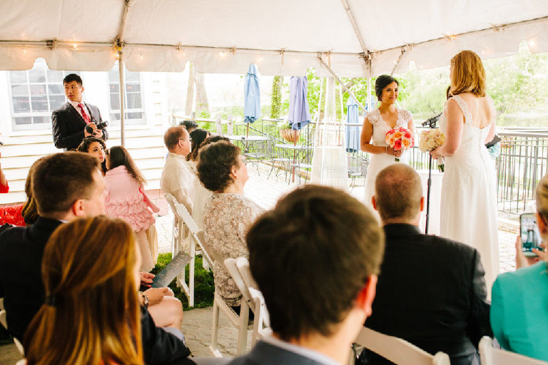 brides face each other smiling at a small same sex LGBT wedding at 1740 House