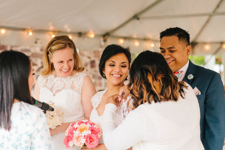 Cousins of the bride pin on the veil at a Pinoy Filipino same sex wedding outside New Hope PA at the 1740 House by Kasey Ivan Photography