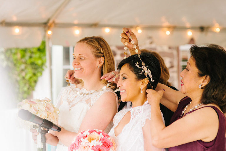a yugal of coins is placed over brides at a Pinoy wedding ceremony in New Hope Pennsylvania at the 1740 House by Kasey Ivan Photography