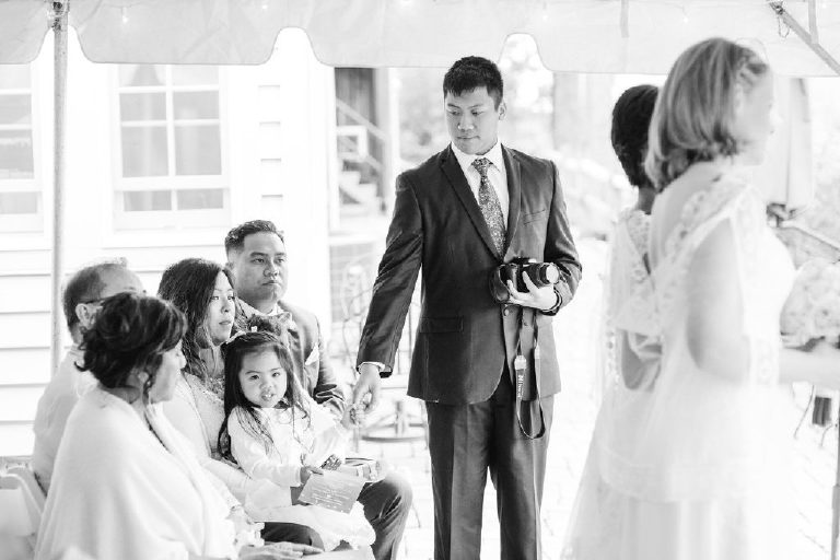 guest holds young girl's hand at an intimate and relaxed wedding ceremony at the 1740 House