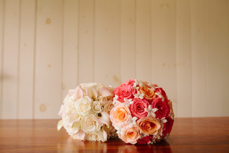 two bridal bouquets of roses sit on a table at the 1740 House in New Hope PA
