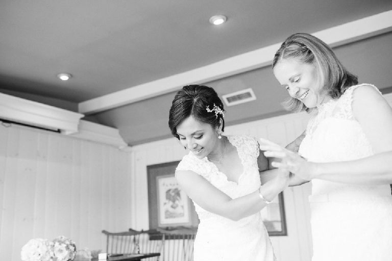 two young lesbian brides discuss their dresses in their room at the 1740 House before a LGBT wedding outside New Hope PA by Kasey Ivan Photography